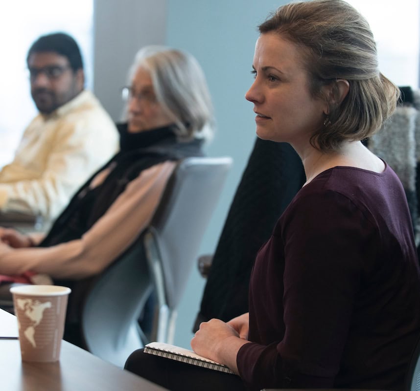 Woman sitting in conference room with a coffee Woman sitting in conference room with a coffee